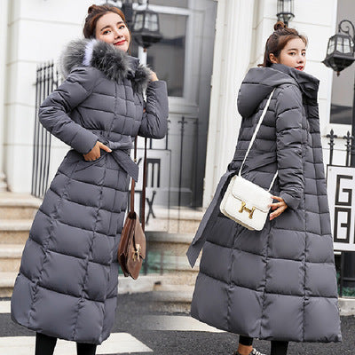 Quilted women's winter coat with hood and belt