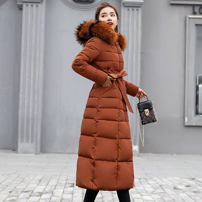 Quilted women's winter coat with hood and belt