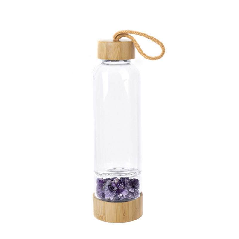 Glass water bottle with energy crystal pebbles