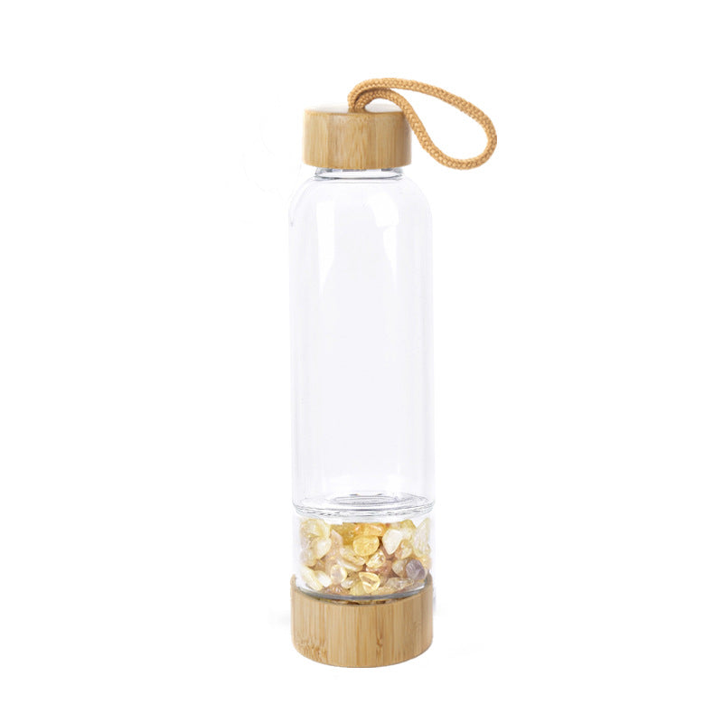 Glass water bottle with energy crystal pebbles