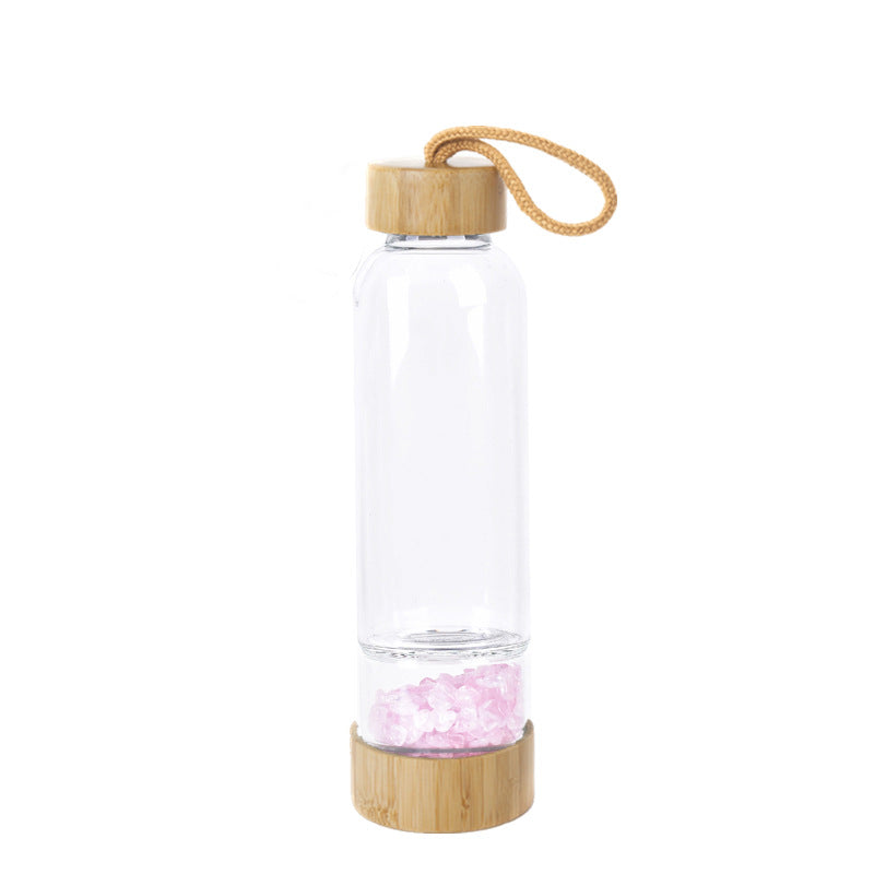 Glass water bottle with energy crystal pebbles