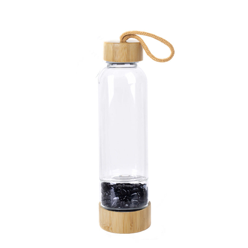 Glass water bottle with energy crystal pebbles