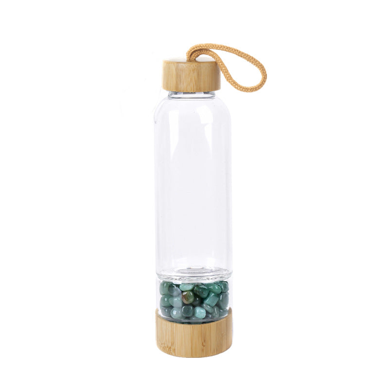 Glass water bottle with energy crystal pebbles