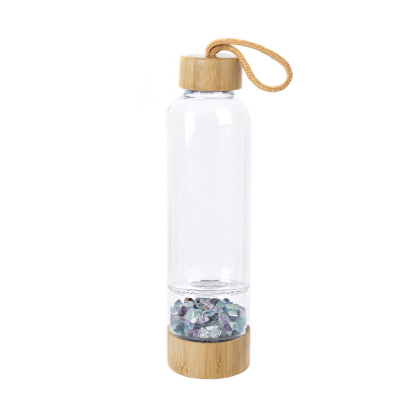 Glass water bottle with energy crystal pebbles