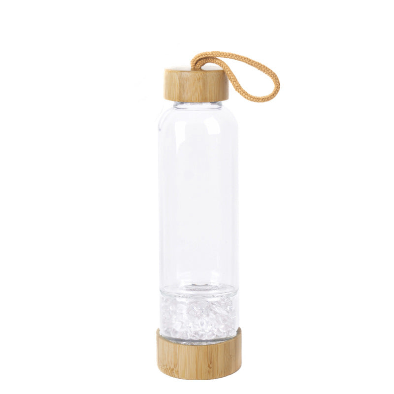 Glass water bottle with energy crystal pebbles